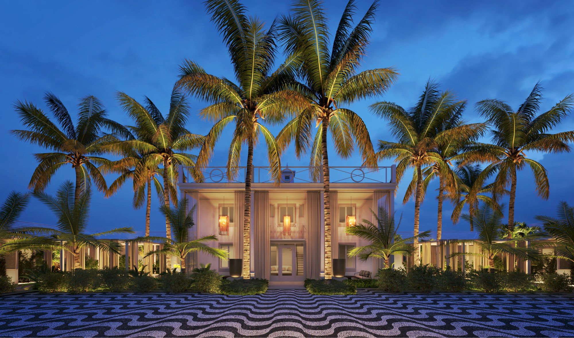 A luxurious building surrounded by palm trees is illuminated at night, with a patterned pathway in the foreground.