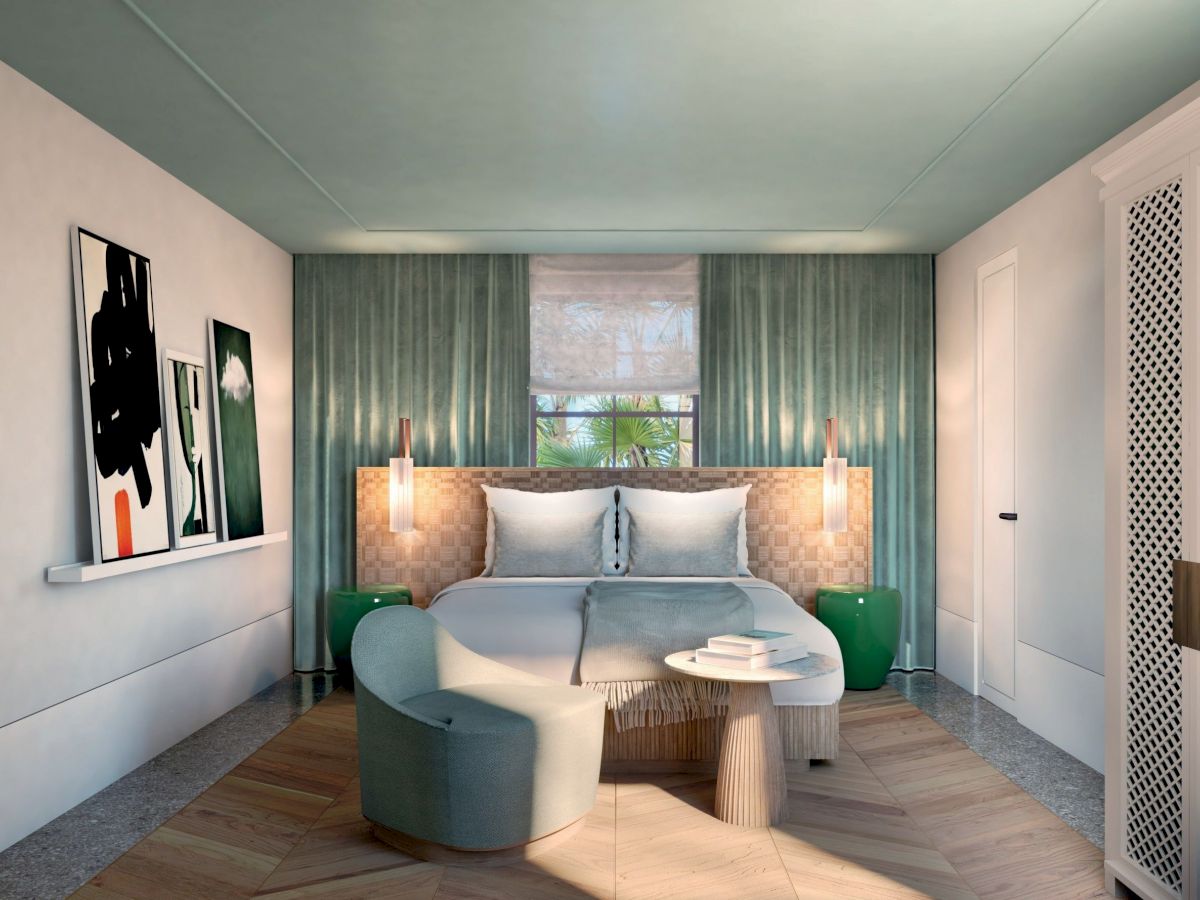 A modern bedroom with a bed, abstract art, green accents, and cozy seating. The room has a calm, stylish ambiance.